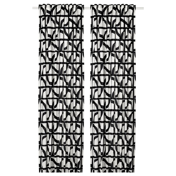 Black and white patterned curtains with abstract shapes, hanging straight. Modern and stylish design, made of cotton.