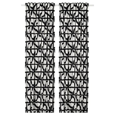 Black and white patterned curtains with abstract shapes, hanging straight. Modern and stylish design, made of cotton.
