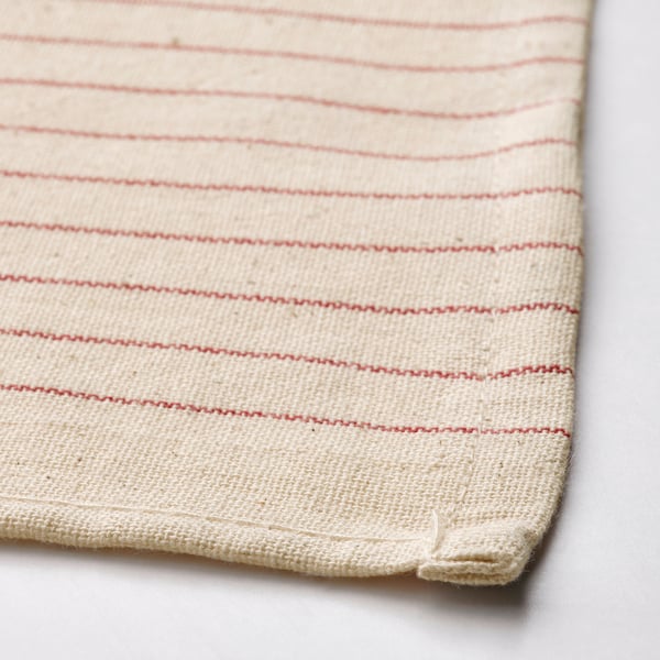 Cream-colored cloth with red stripes, neatly stitched, showcasing high-quality cotton texture.