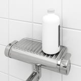 A chrome bathroom shower mixer a built-in shelf holding a white bottle, perfect for storing tall shampoo bottles.