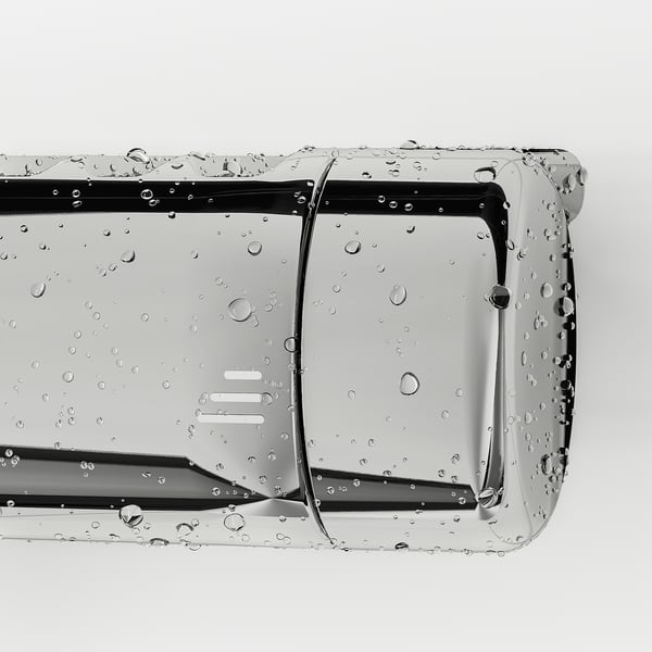 Close-up of VOXNAN shower mixer: chrome surface, droplets, safety stop, built-in shelf.