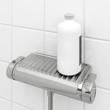 Shower mixer with built-in shelf holding bottle, safety stop button, and anti-scald technology.