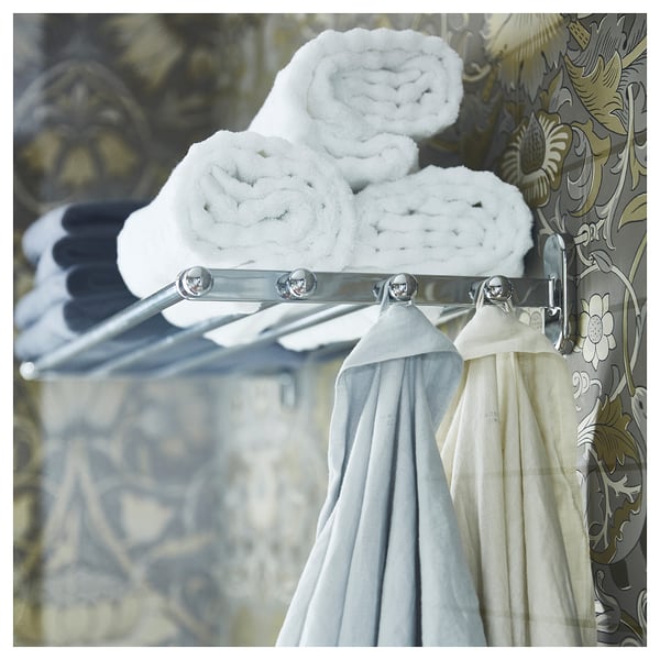 VOXNAN silver towel shelf with hooks, holding rolled white towels and hanging white towels.