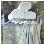 VOXNAN silver towel shelf with hooks, holding rolled white towels and hanging white towels.