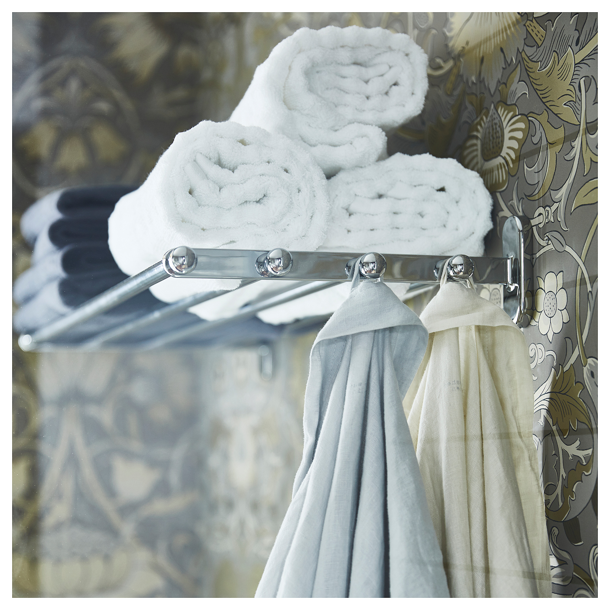 VOXNAN silver towel shelf with hooks, holding rolled white towels and hanging white towels.