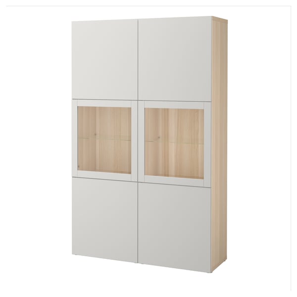 Ett benvitt BESTÅ-skåp med trädörrar som kombinerar förvaring och display.