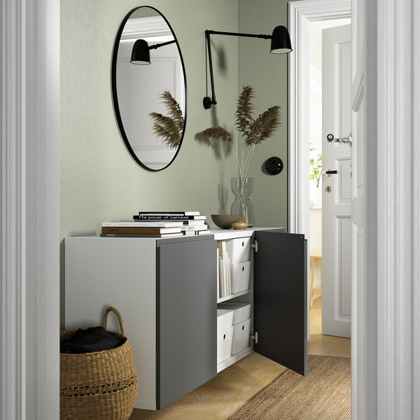 Modernt vägghängt skåp, öppet med förvaring, böcker och korg. Luftig design.