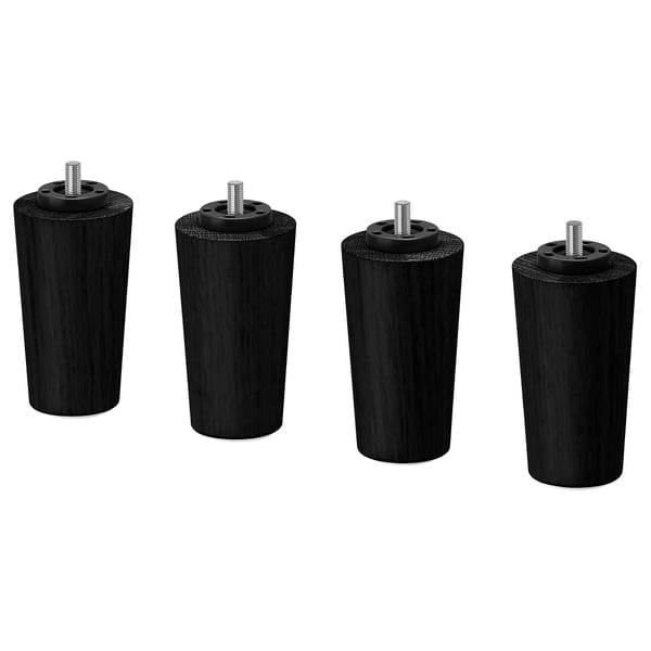Fyra identiska svarta cylindriska träben med gängade skruvar på toppen. Robust och klassisk design.