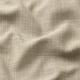 Närbild av texturerat, högkvalitativt tyg blandas i neutrala toner.