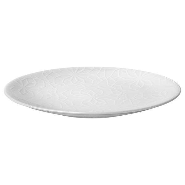 En vit GOKVÄLLÅ sidoplatta. Den är cirkulär, med ett präglat geometriskt mönster och tillverkad av slitstarkt porslin.