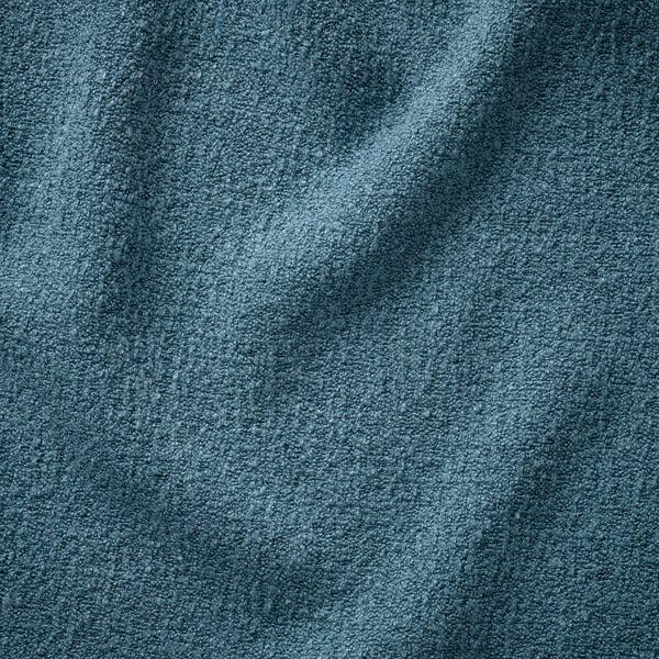 Mjukt, texturerat teal-överdrag med subtila mönster, troligen gjort av återvunnet material för miljövänlig värme.