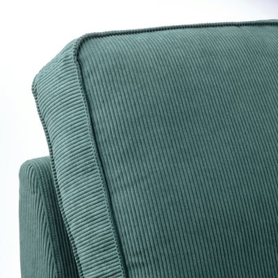 Närbild av plysch, texturerad blågrön manchestersoffsektion, som visar upp mjuk, inbjudande textur och robust konstruktion.