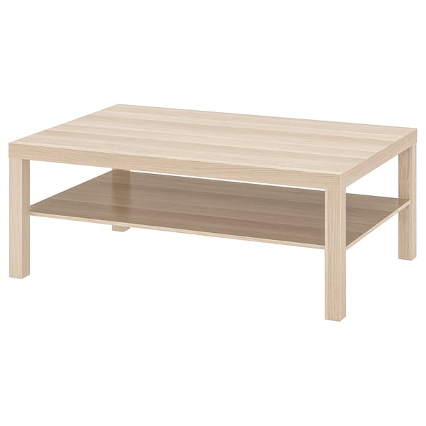 Beige ikea LACK soffbord med över- och underhylla.
