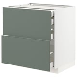 Ett modernt köksskåp med två gröna lådor och snygga handtag, med en minimalistisk och funktionell design.