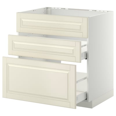 Ett vitt och beige köksskåpssystem med lådor. Det är en modern, minimalistisk design med smidigt integrerad hårdvara.