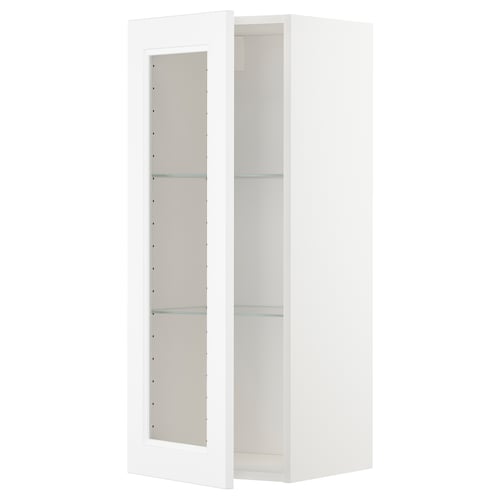 Den här bilden visar ett vitt METOD-köksskåp med glasdörrar, med en elegant, rektangulär design.