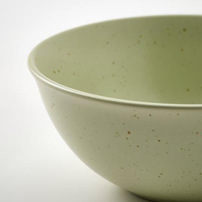 Stor, ljusgrönspräcklig keramisk skål, enkel, rund form.