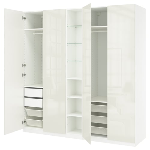Vit IKEA PAX garderob med hyllor, lådor och nätkorgar.
