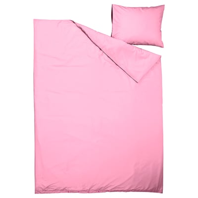 Ljusrosa täcke och kuddset, modern design, slätt tyg.