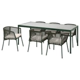 Modern uteservering med mörkgrönt metallbord med fyrkantig glasskiva och matchande stolar med beige kuddar.