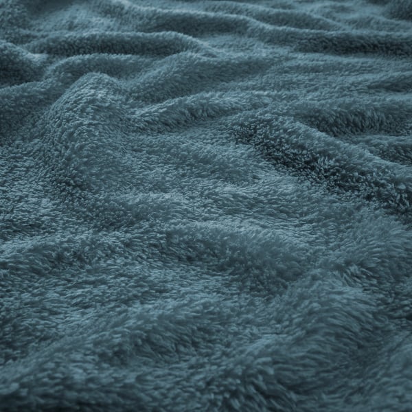 Närbild av mjuk, texturerad blå fleece; Varmt, lätt och mysigt.