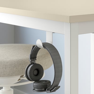 Modernt beige mötesbord med väggmonterad hörlurskrok för flexibla, spontana möten.