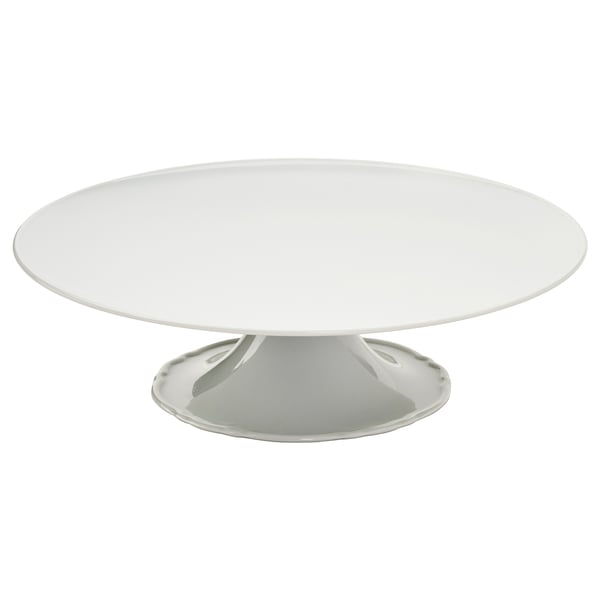 Ett vitt UPPLAGA-tårtfat i porslin med en volangkant, perfekt för att servera godsaker på ett elegant sätt.