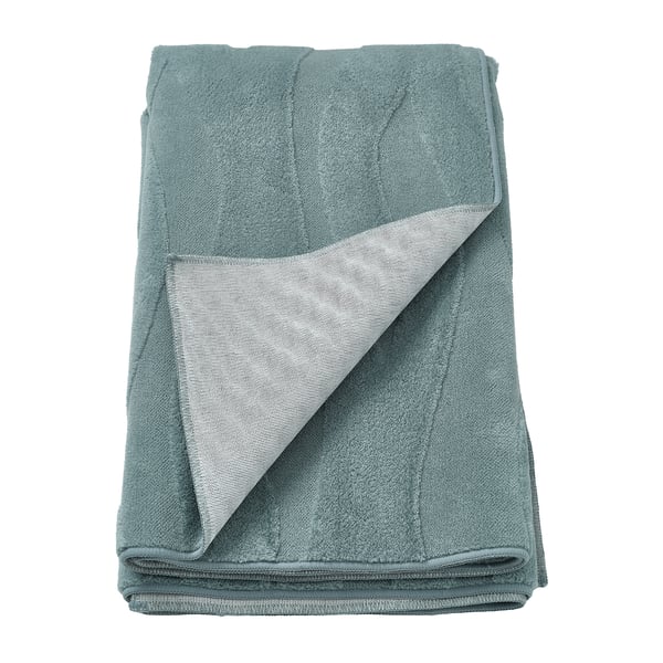 Vikt grön VÄXELFEL-matta med texturerat 3D-mönster, gjord av återvunnen polyester, visad på vit bakgrund.
