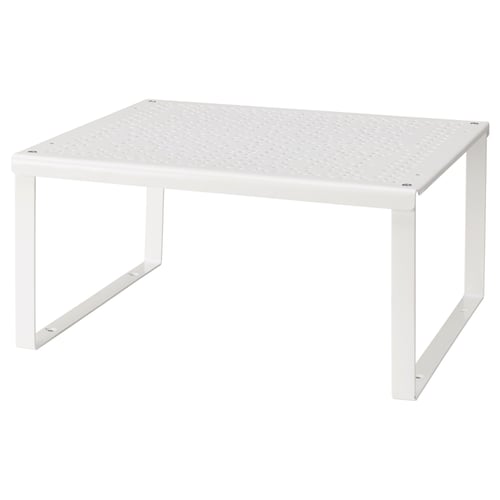 En vit hyllinsats VARIERA. Den är fyrkantig med en perforerad topp, som stöds av fyra metallben.