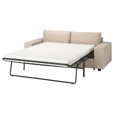 En beige VIMLE bäddsoffa med en ljus bäddmadrassförlängning, med en enkel och modern design.