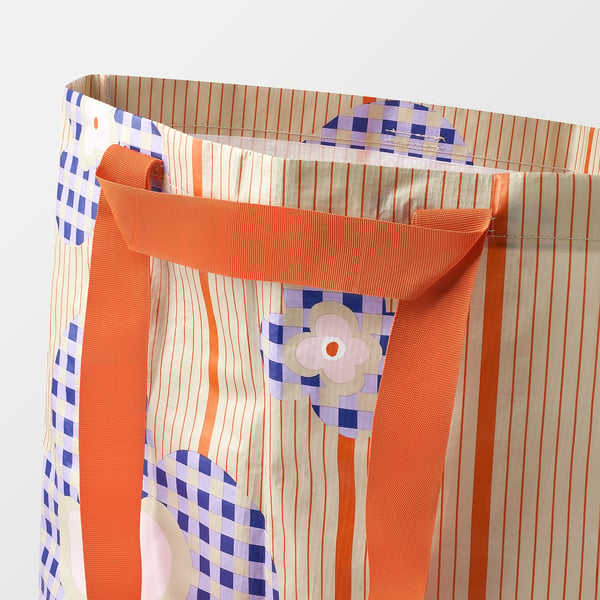 Colourful striped reusable shopping bag with mesh handles, showcasing durable and eco-friendly design.