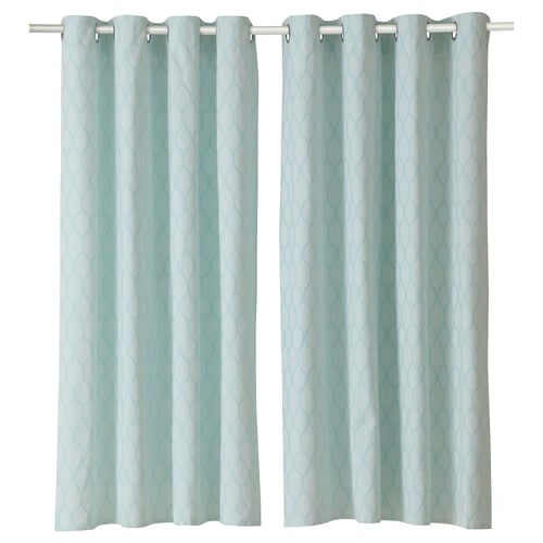 Two light blue curtains with a medallion pattern hang side by side. They have a silver rod and grommet design.