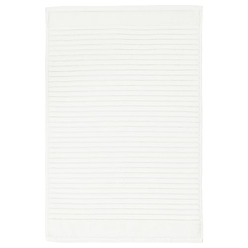 A white, rectangular ALSTERN cotton terry bath mat. Its design a textured surface for foot massage and quick drying.
