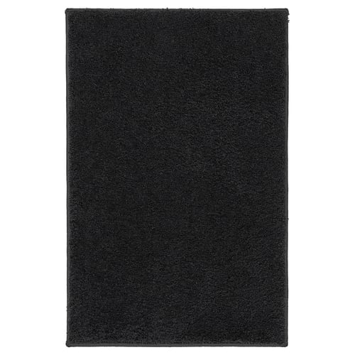 BACKMÅRA black bath mat; rectangular, soft recycled polyester, latex backing for grip, coordinates with bathroom textiles.