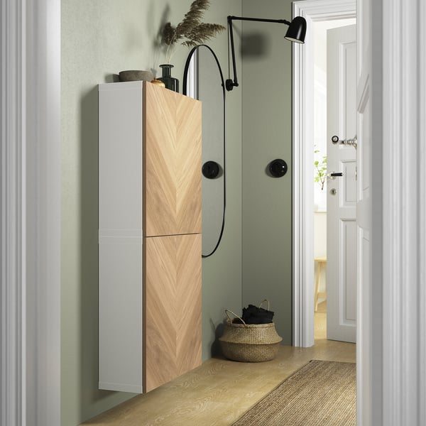 White BESTÅ cabinet, slim & tall, with soft-close hinges & decor.
