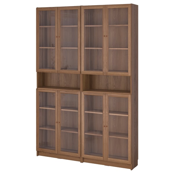 A BILLY bookcase with glass doors. It oak-colored wood and six glass-fronted compartments.