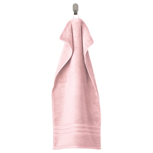 BROKGLIM light pink towel hangs neatly on a hook, featuring a textured design and elegant border.