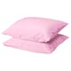 Two soft, light pink DVALA pillows with a smooth, square shape and simple, clean design, made from 100% cotton.