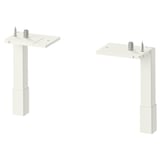 Two white metal ENHET cabinet legs, each with adjustable screws, standing upright. Simple, minimalist design for stability and airy look.