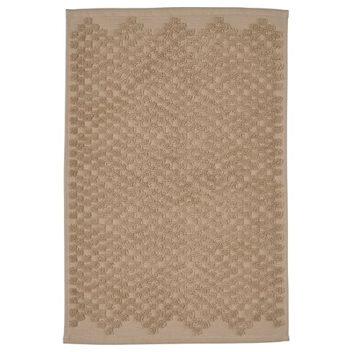 Image shows a beige FJÄLLKATTFOT bath mat, rectangular, with a textured terry cloth design for comfort and high absorbency.