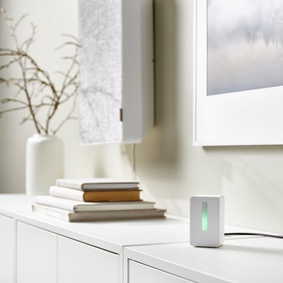 Grey FÖRNUFTIG air purifier with handle, stand, and sensor. Modern, portable design.