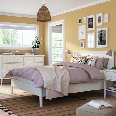 Bright bedroom with GULLABERG bed, pastel linens, white furniture, wall art.