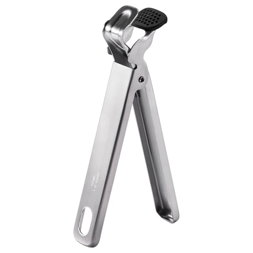 Silver stainless steel kitchen tool with black silicone pad, v-shaped handles, ideal for gripping and opening.