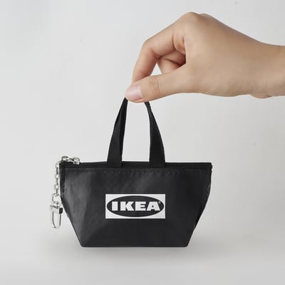 Black KNÖLIG coin bag with keychain and zip.