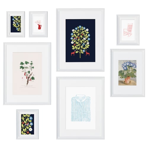 A gallery wall with seven KNOPPÄNG floral artworks in blue, green, and red frames.