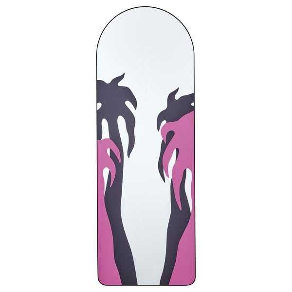 The KONSTRUNDA mirror a pink and black plant design, framed in recycled aluminium. Its arched shape adds a unique touch to any room.