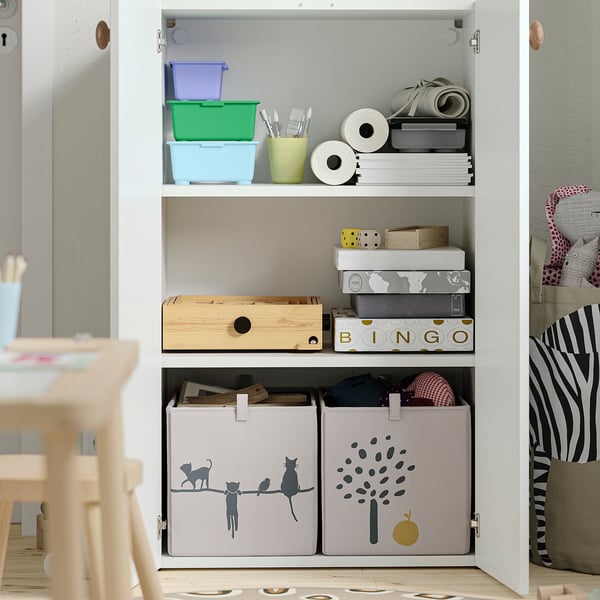 Open storage unit with colourful boxes, paper rolls, games, and fabric bins. Adjustable feet for floor levelling.