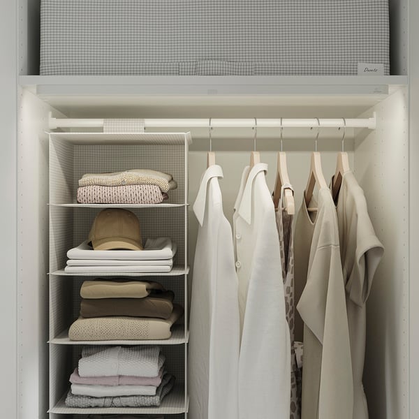 Organised closet with neatly folded clothes and hanging garments, featuring adjustable shelves and hanging rods.
