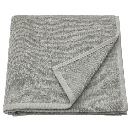 Folded grey LUDDVIAL cotton towel, soft, lightweight, neatly folded square shape with visible terry texture.