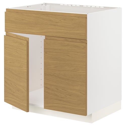 A white and oak kitchen cabinet from the METOD system, featuring a modern, minimalist design with integrated handles.